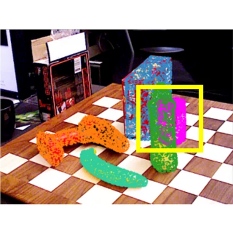 Colored point overlays on tabletop objects, with a yellow box highlighting one object.